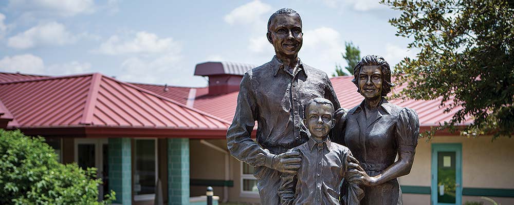 slide image of statue in front of ahrens family center