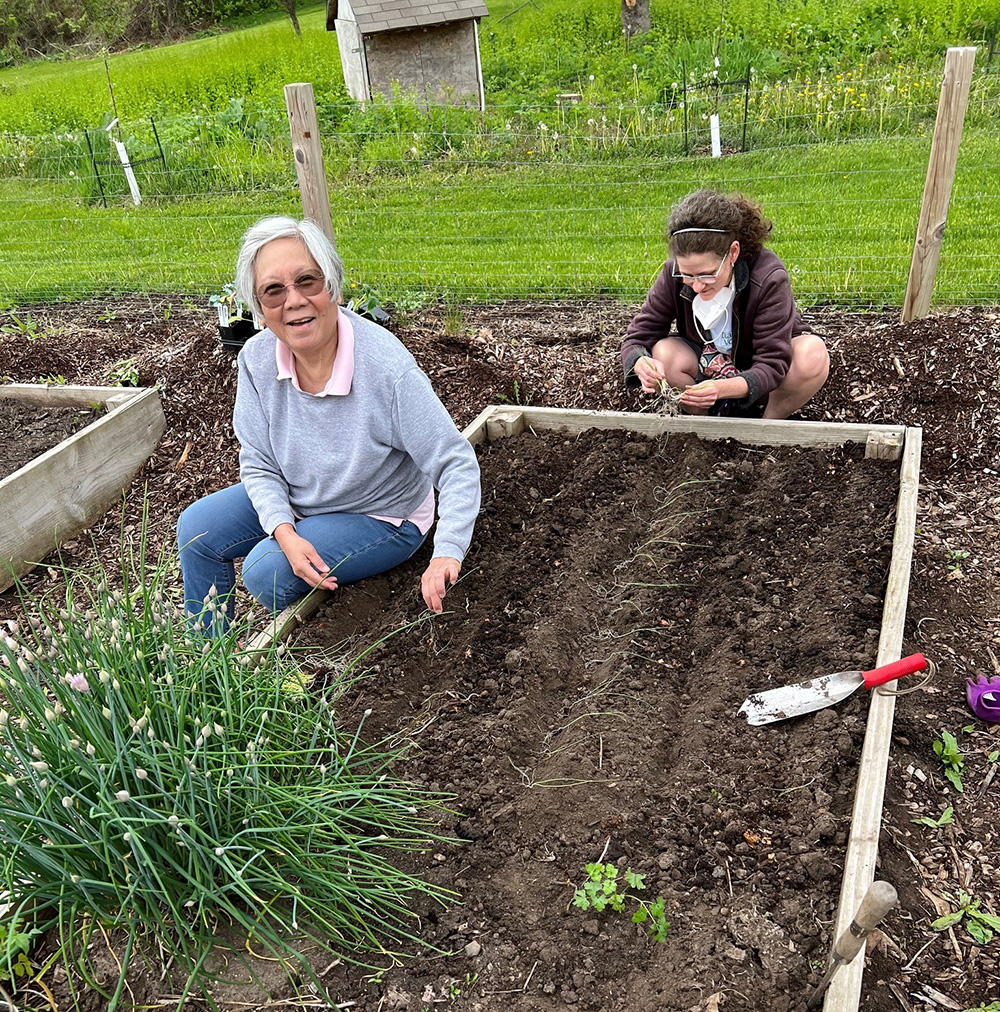 woman and girl preparing garden